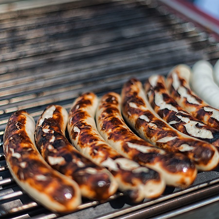 St Galler bratwurst on a grill at a market.