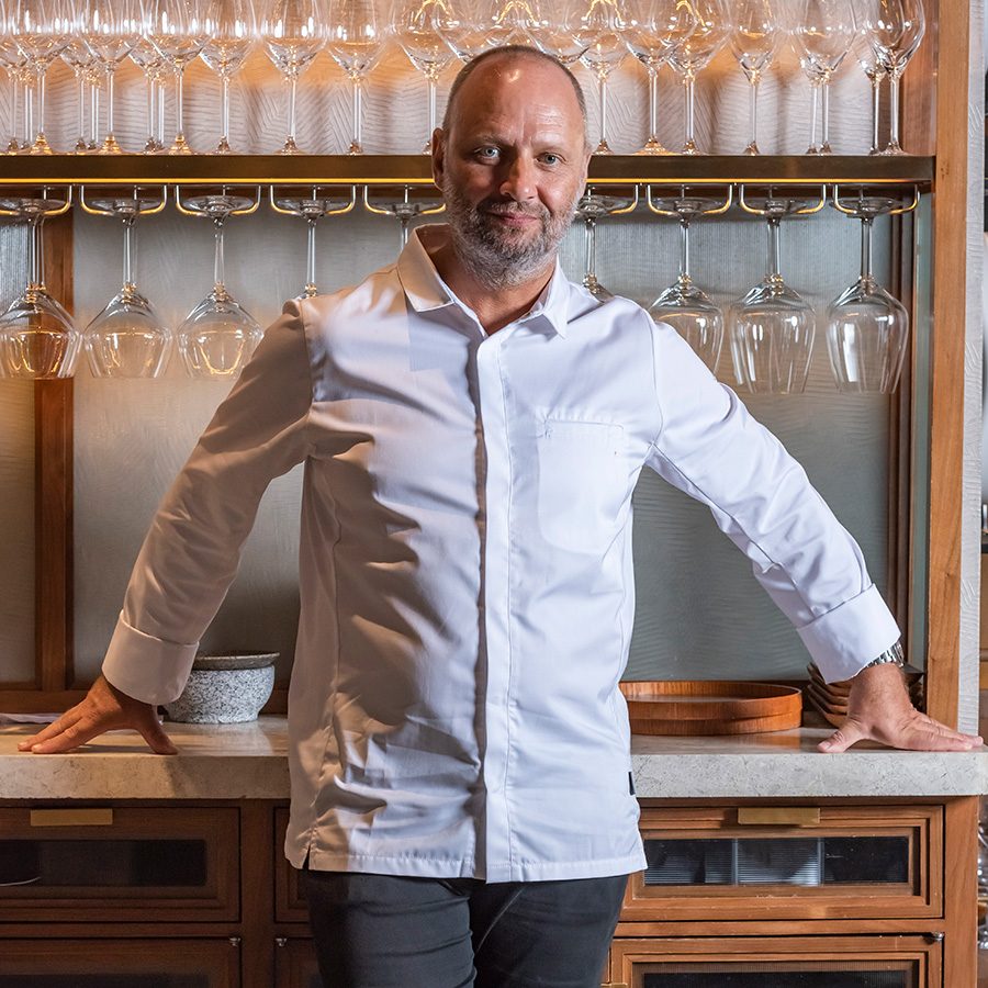 Man standing in front of glassware at Roganic.