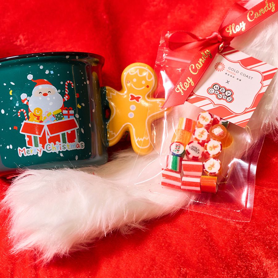 Products such as painted cups, cookies and confectionery from homegrown brands in Hong Kong, placed on a red pillow. 
