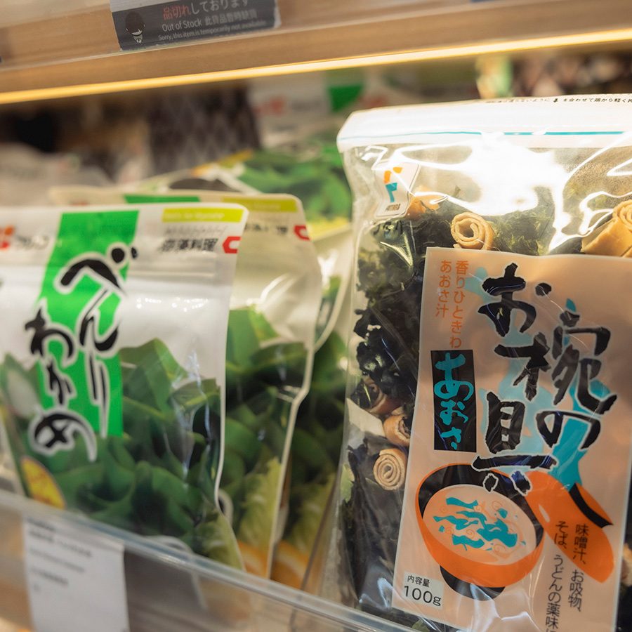Packages of kombu and soup packets on the shelf at a supermarket selling Japanese food.