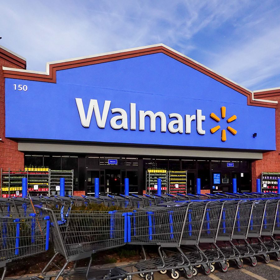Exterior of a Walmart store in the United States behind a big row of shopping carts. 