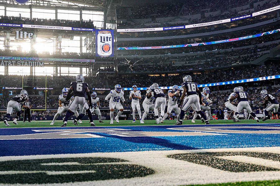 Players in action during a football match at the AT&T Stadium.