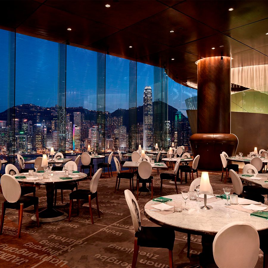 An interior view of the dining area inside Felix restaurant at The Peninsula Hong Kong with panoramic views of Victoria Harbour and Hong Kong skyline.