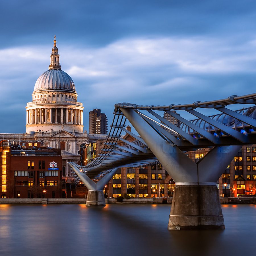 A wide view of Millenium Bridge in London, in the evening after sunset 