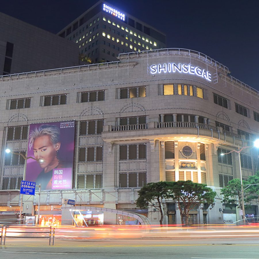 Façade of Seoul’s Shinsegae Department Store at night. 