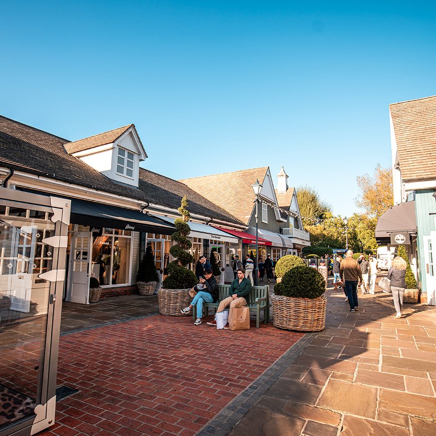 Shoppers strolling on brick paths in Oxfordshire’s Bicester Village.  