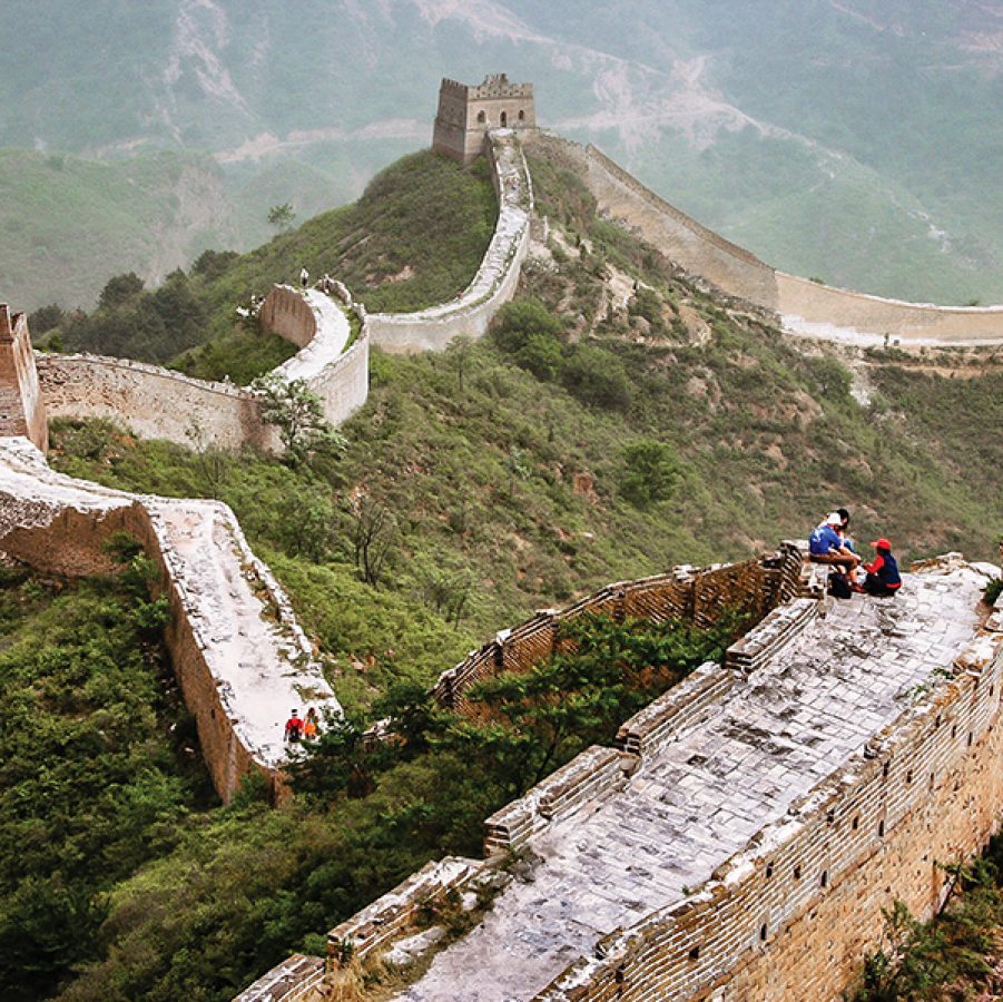 Aerial view of a section of the Great Wall between Jinshanling and Simatai in Beijing. Hikers can be seen walking on the path.