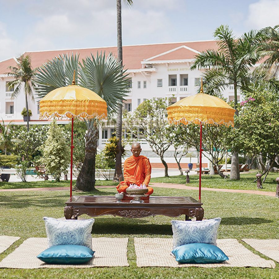 A monk performing a sacred blessing at Raffles Grand Hotel d’Angkor in Siem Reap.