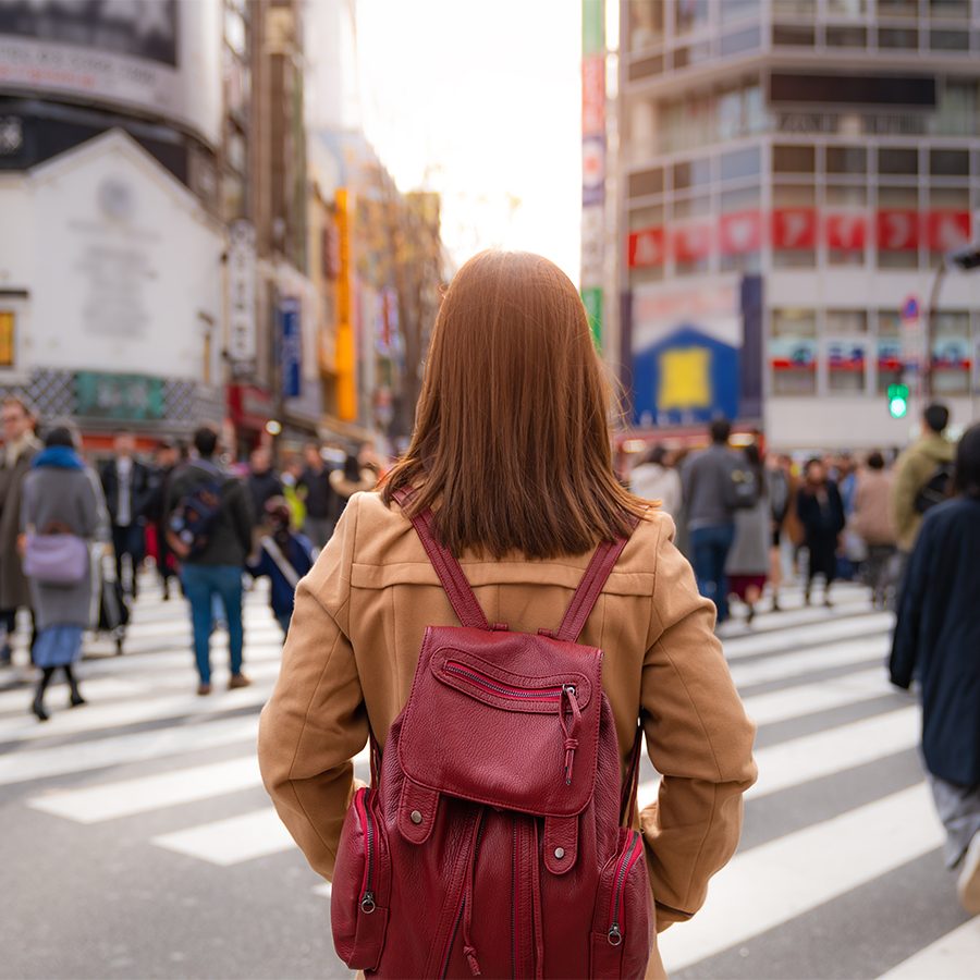 Woman with backpack standing in Shibuya crossing