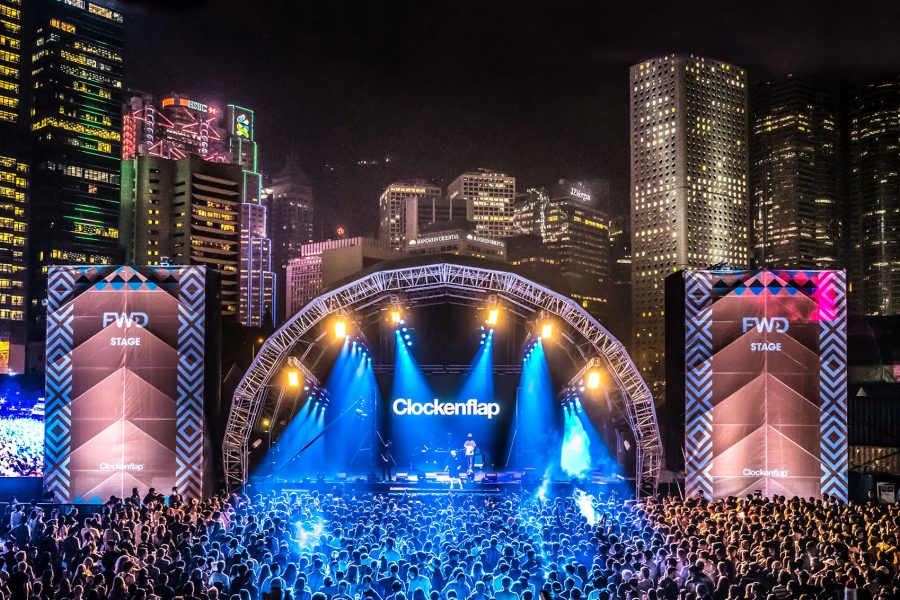 Large crowd at the Clockenflap stage on Hong Kong harbourfront at night.
