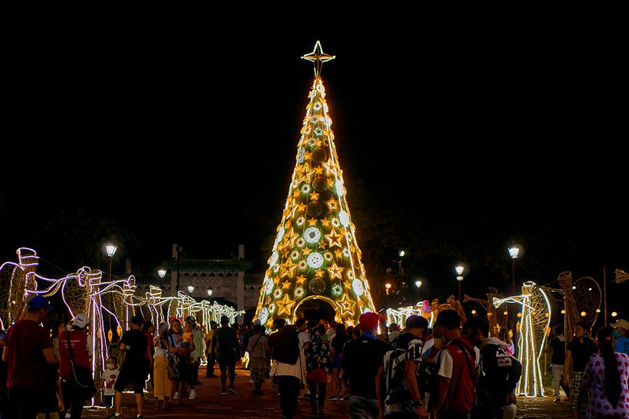 A large lit-up Christmas tree in Rizal Park, Philippines during the holiday season. 