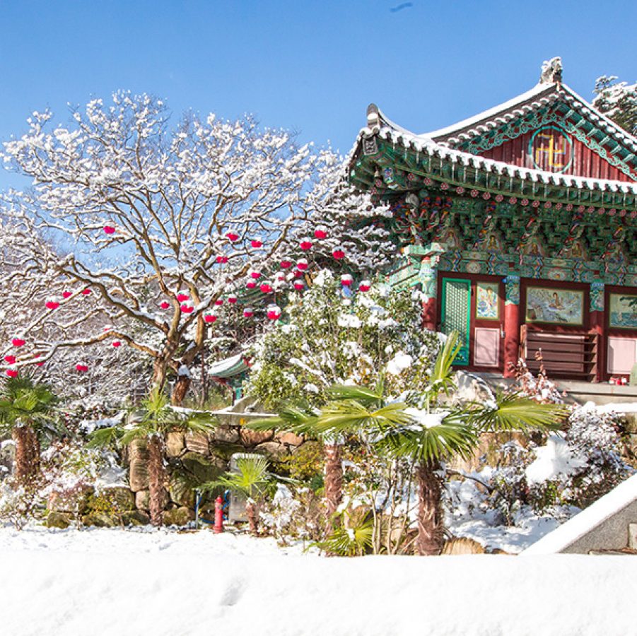 A snow-covered temple in South Korea during winter.