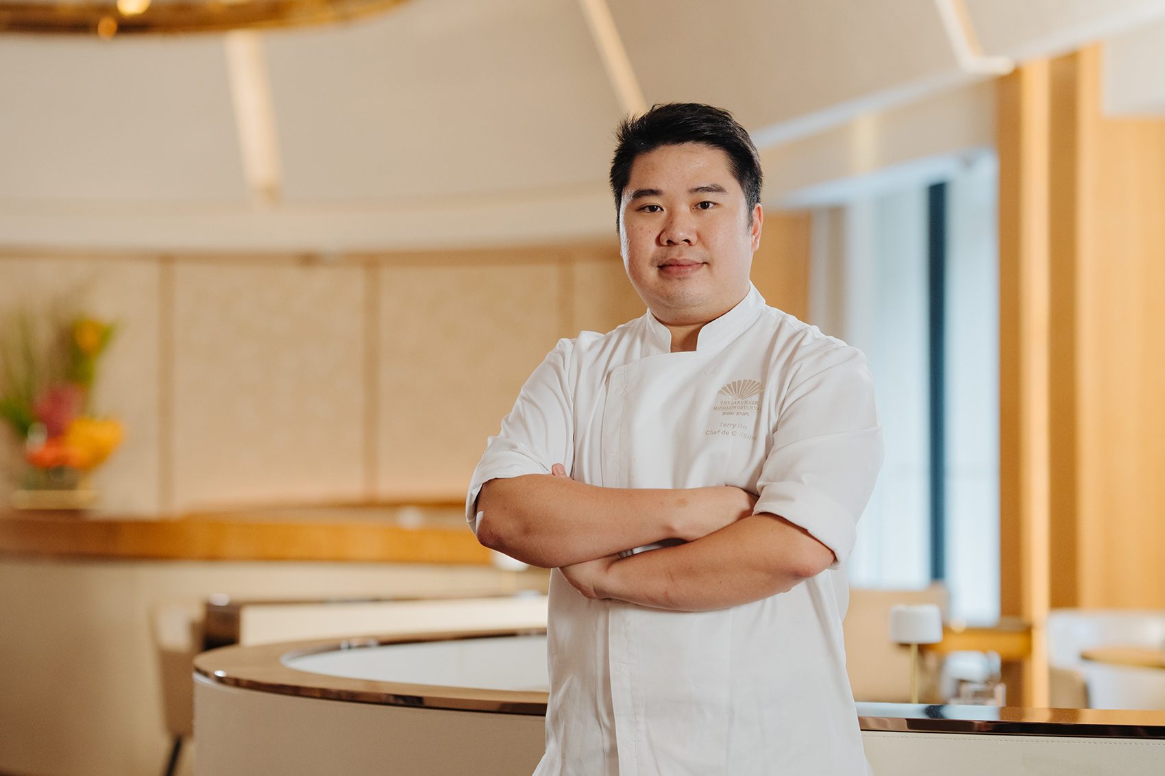 Terry Ho poses in his chef’s uniform at Amber restaurant.  