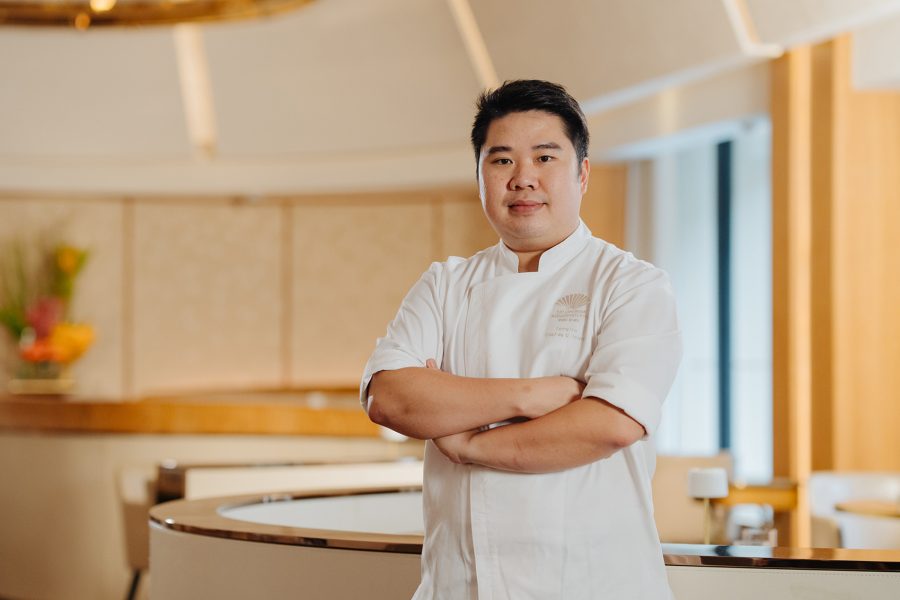 Terry Ho poses in his chef’s uniform at Amber restaurant.  