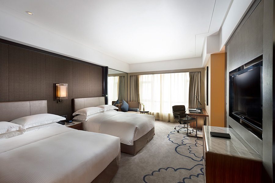 An interior view of the bedroom at Hilton Zhongshan Downtown. 