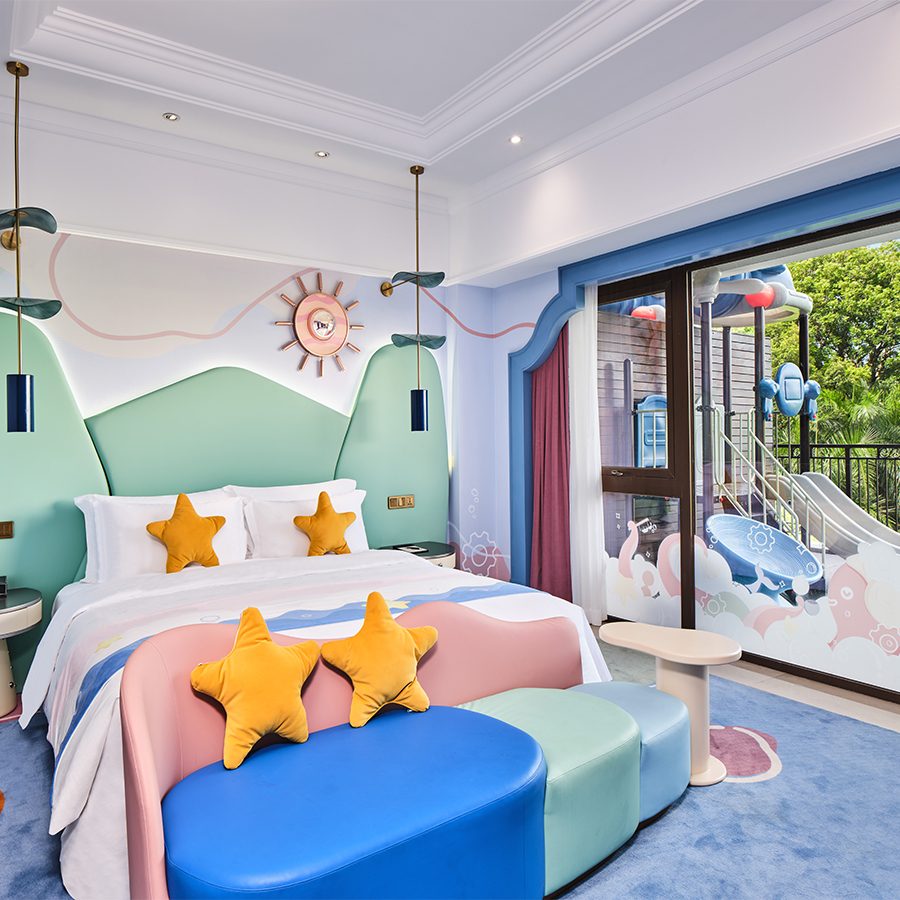 An interior view of the family suite with playful decor and furnishing and a large window with a view of the playground on the terrace at InterContinental Shenzhen. 