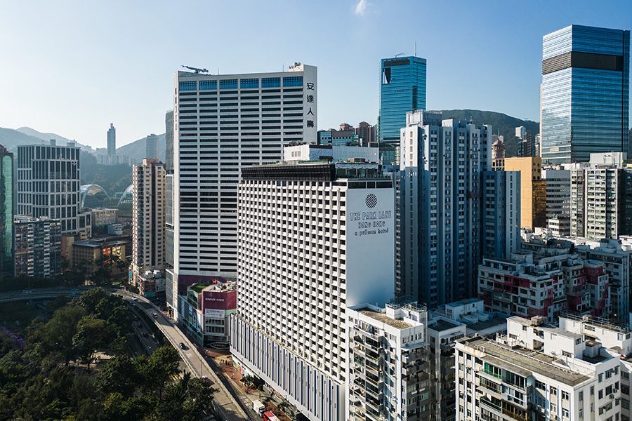 A bird’s eye view of Causeway Bay skyscrapers and the exterior of The Park Lane Hong Kong hotel during daytime. 