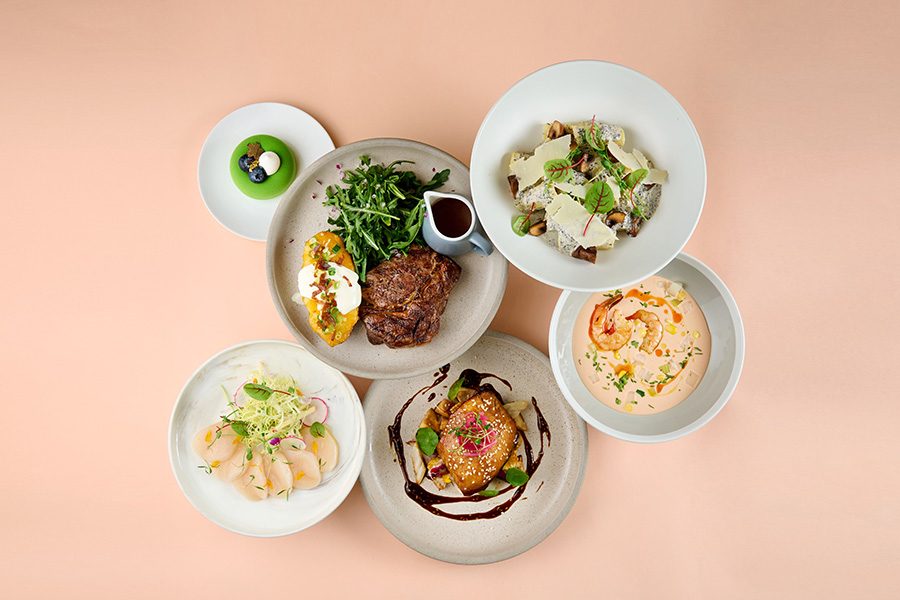 A top down shot of various dishes served at Ebb & Flow at The Park Lane Hong Kong hotel.