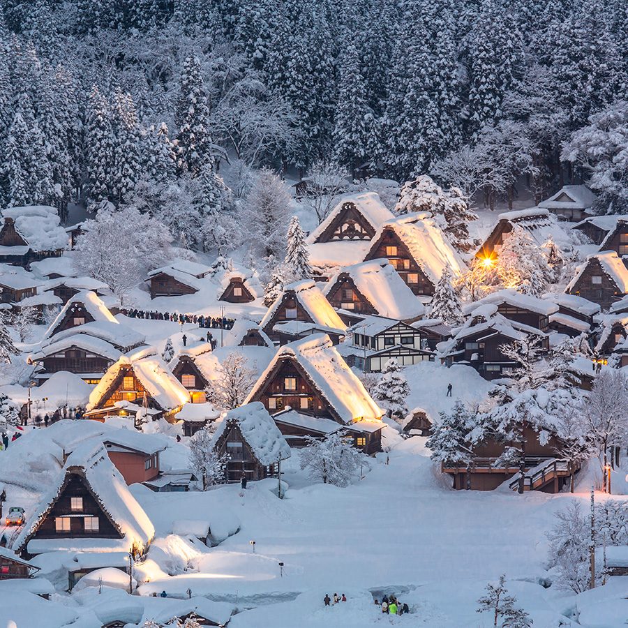 Wide shot of snow-covered farmhouses in Shirakawa-go. 