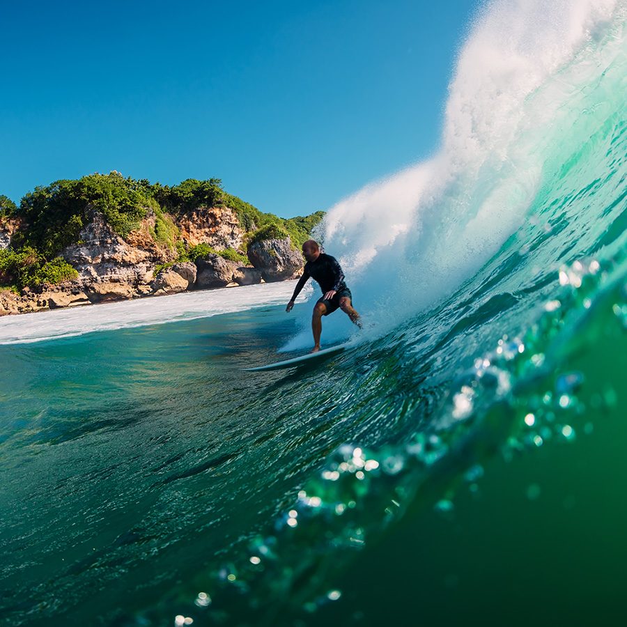 A man surfing in Bali. 