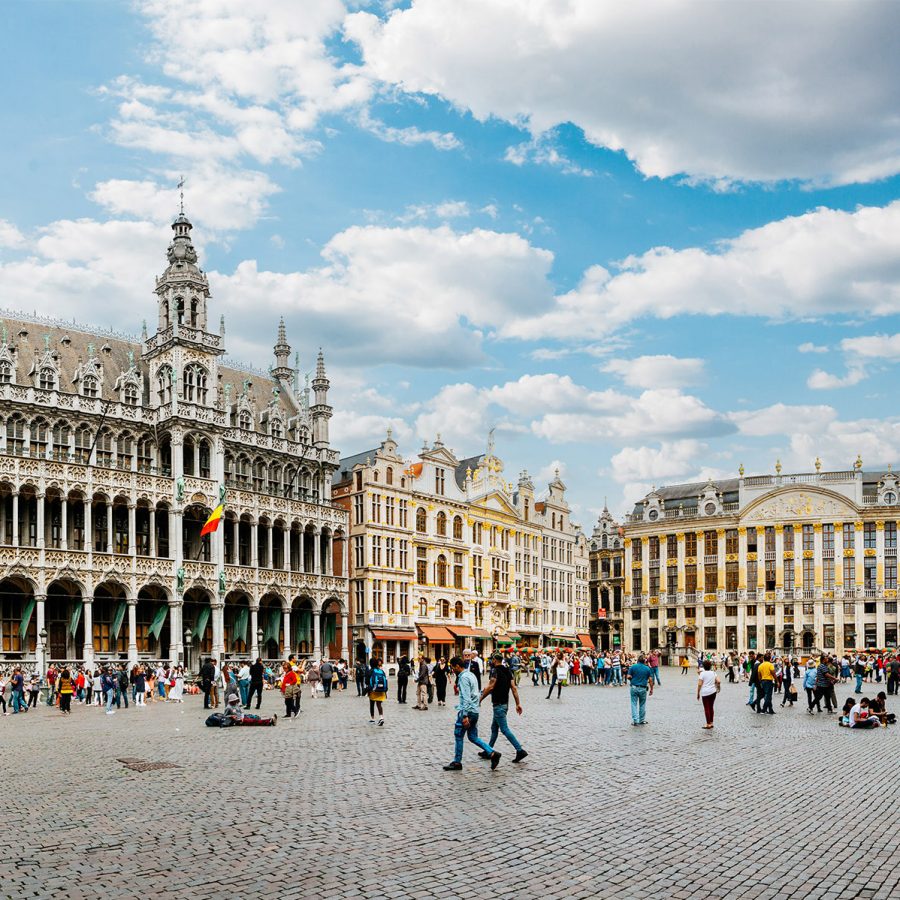 People strolling across the Grote Markt of Leuven, Belgium on a sunny day.