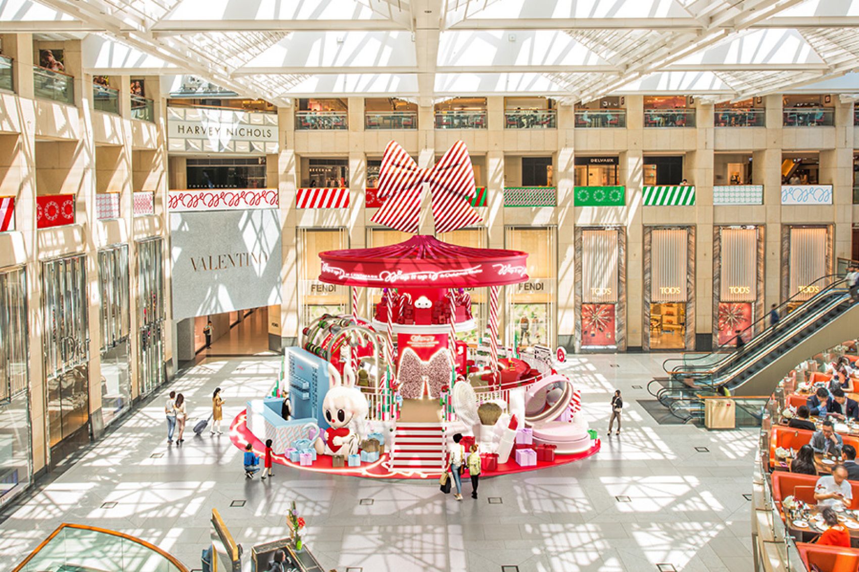An aerial view of the red and white Wrap It Up display in the large glass-ceilinged atrium of Landmark.