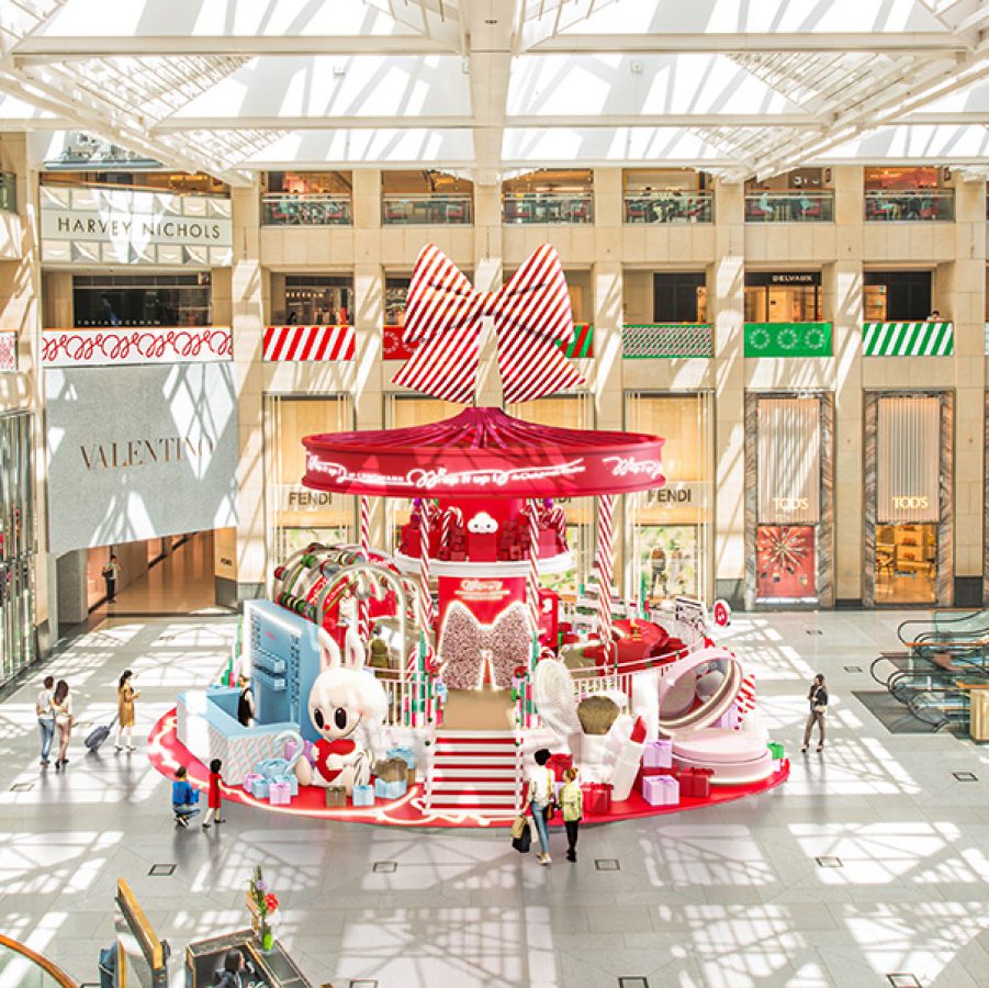 An aerial view of the red and white Wrap It Up display in the large glass-ceilinged atrium of Landmark.