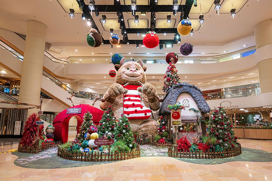 A figure of a giant furry monster towers over the ChristmasVille display at Pacific Place.