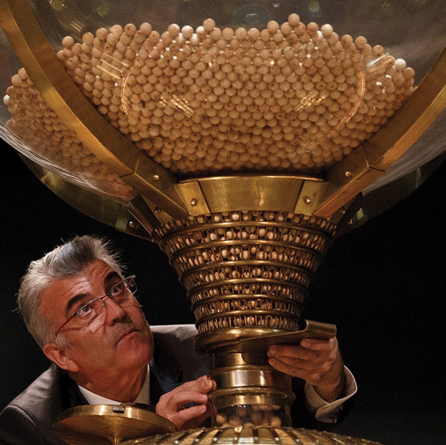 A man carefully drawing the golden Christmas lottery in Madrid.