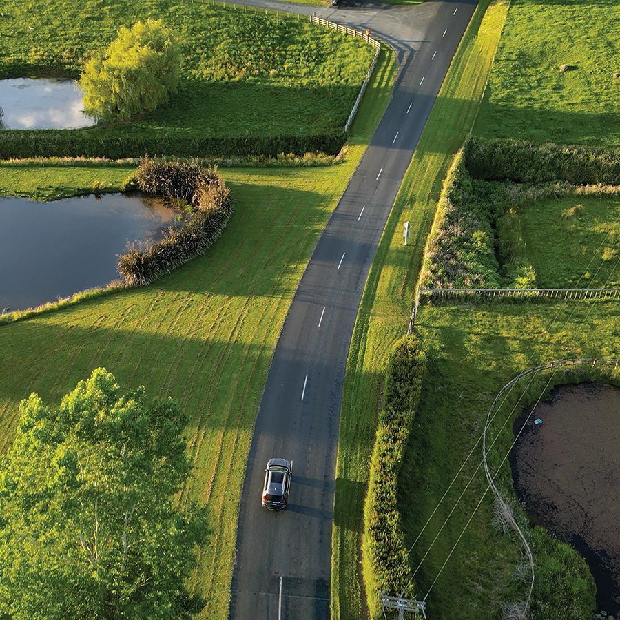 Aerial view of a road surrounded by grassland near the Hobbiton Movie Set.