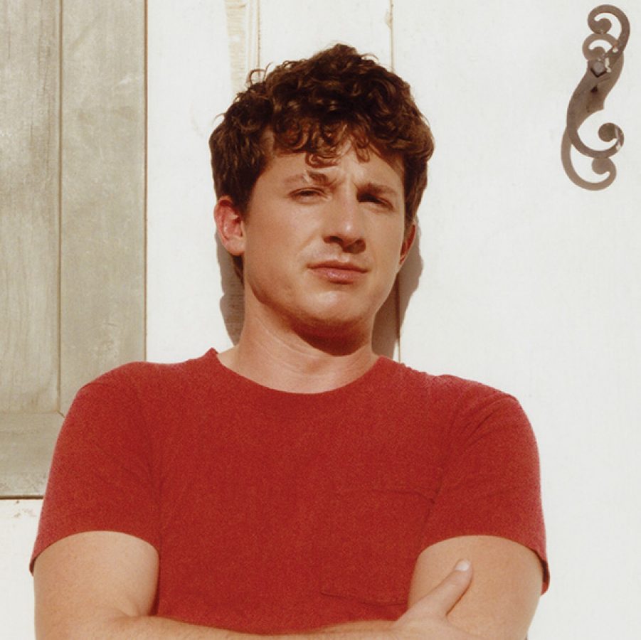 A photo of Grammy-nominated singer-songwriter Charlie Puth in orange.