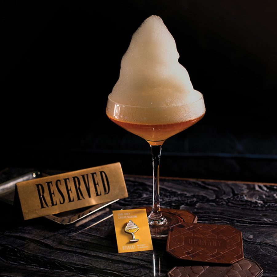 An earl grey caviar martini with a tall foam served at Quinary, Hong Kong.