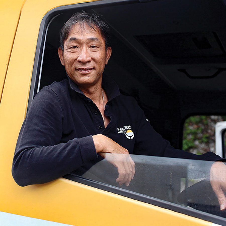 Portrait of a driver for Feeding Hong Kong inside a lorry. 