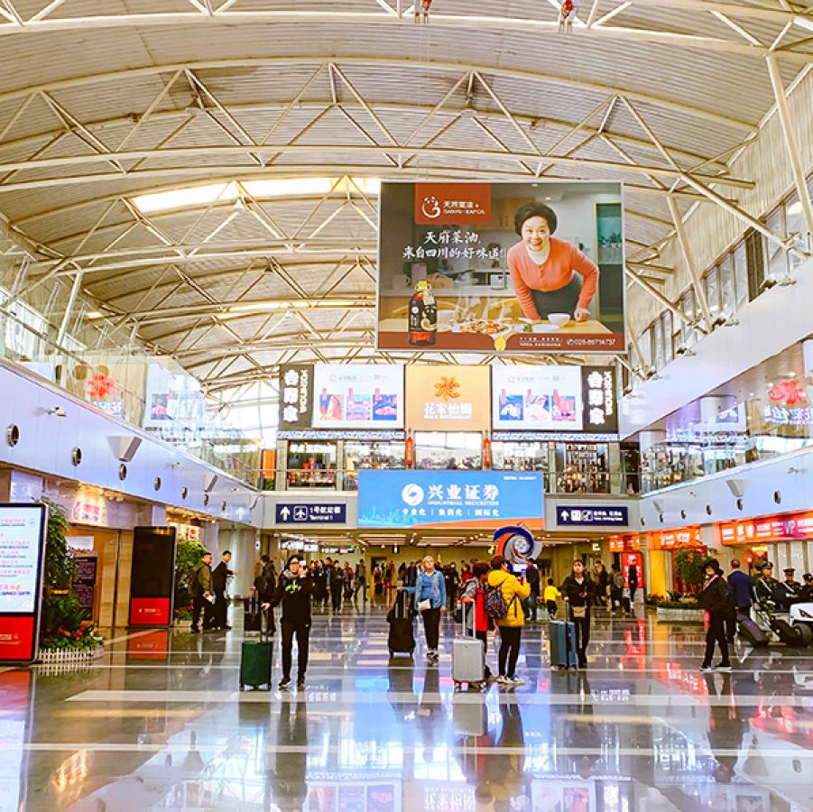 Travellers walking around at the Beijing Capital International Airport, where you can get a Chinese SIM card upon arriving in the Chinese Mainland. 