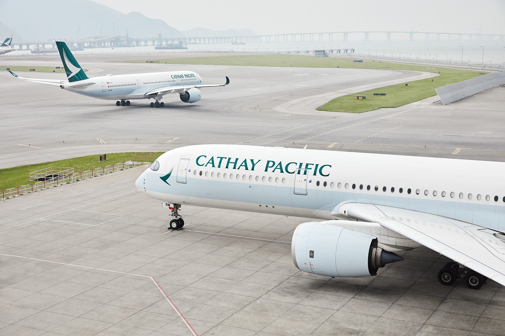 Two Cathay Pacific aircraft on Hong Kong’s third runway at the Hong Kong International Airport during daytime