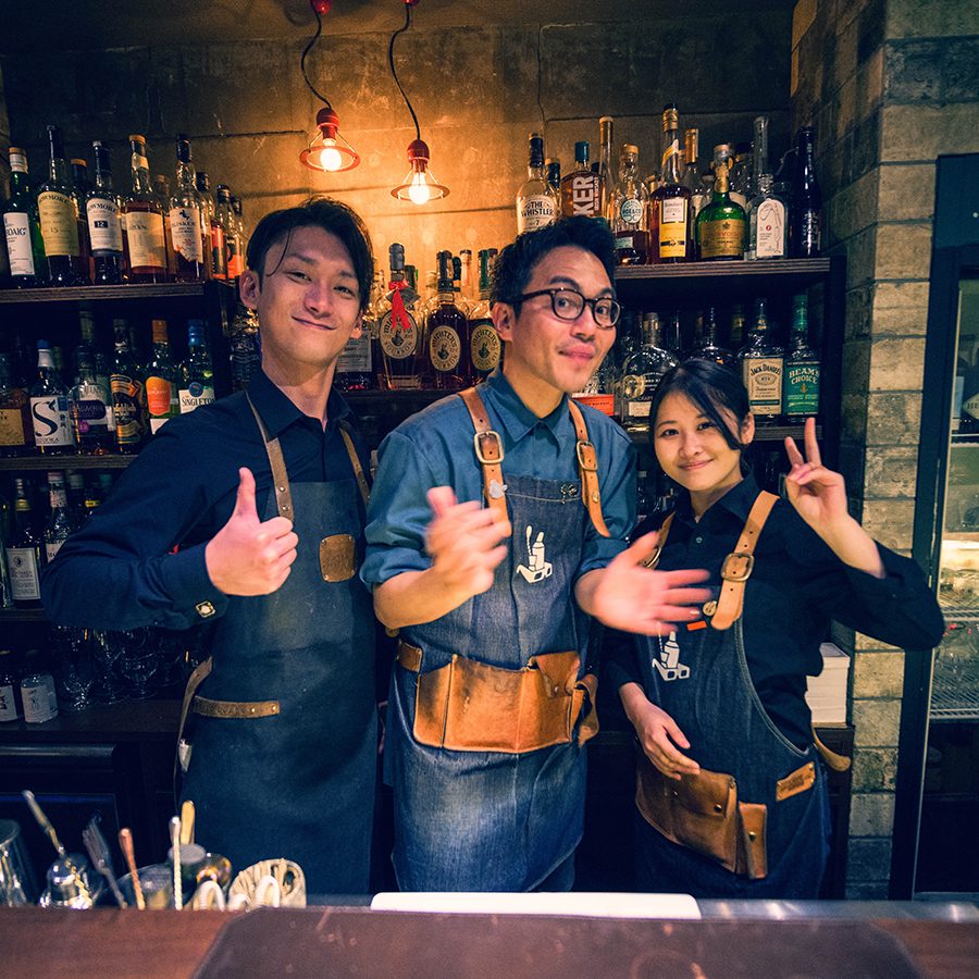 The team at Craftroom in Osaka smiling and posing for a photo from behind the bar.