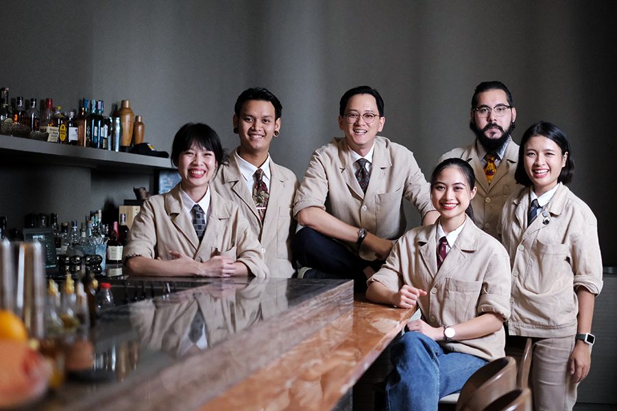 A group photo of Dry Wave Cocktail Studio team at the bar.