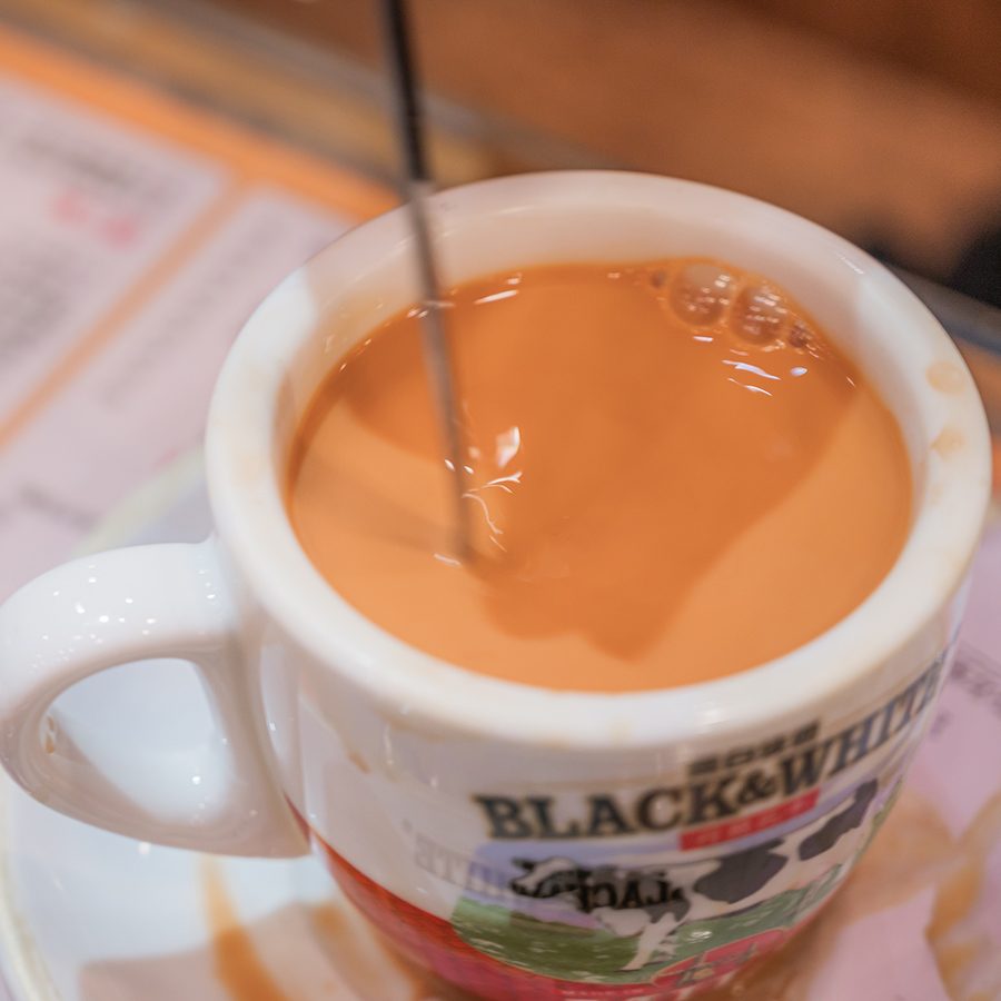 Hot milk tea in a Black & White cup. 