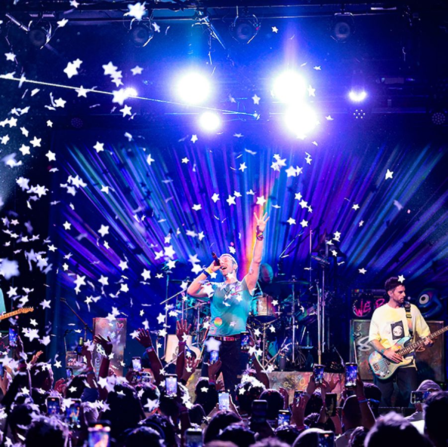 Coldplay performed to a packed crowd against concert lights  