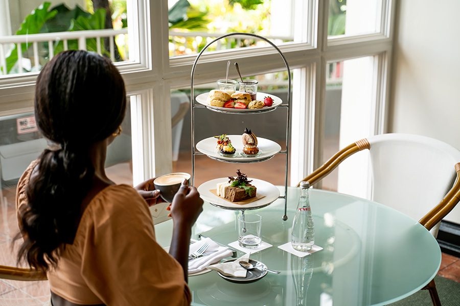 A hotel guest enjoying an afternoon tea set at Pullman Cairns International.