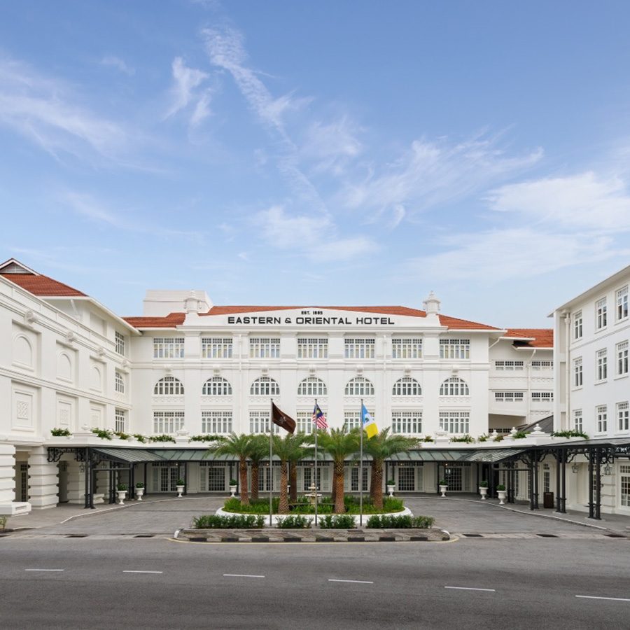 An exterior view of the entrance at Eastern and Oriental hotel during daytime in Penang.