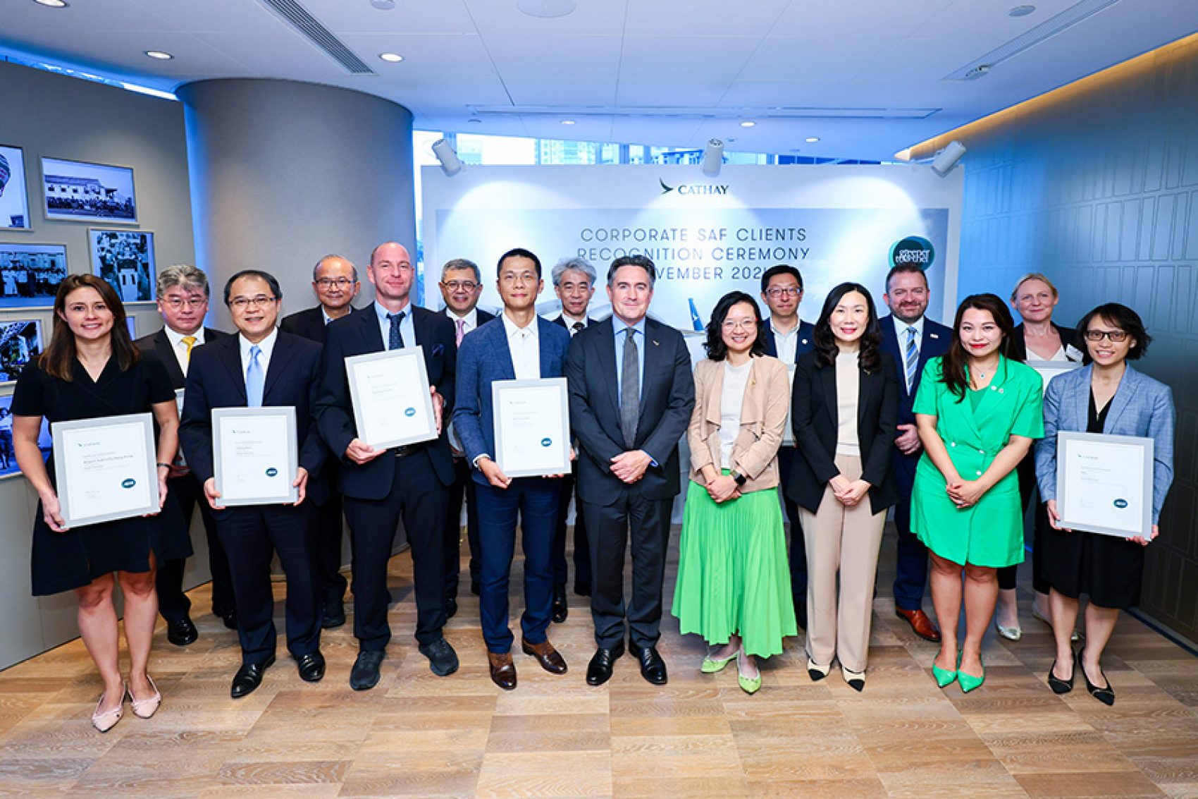 A group photo with Cathay’s corporate partners at the Corporate SAF Clients Recognition Ceremony. Some members are holding certificates.
