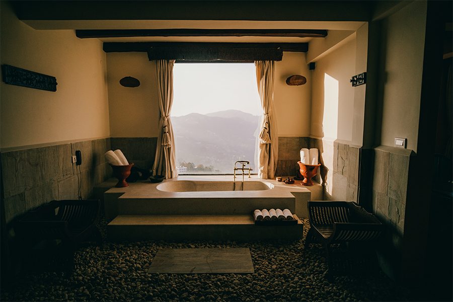 The bathroom at Dwarika’s, Nepal, with a window overlooking the hills. 