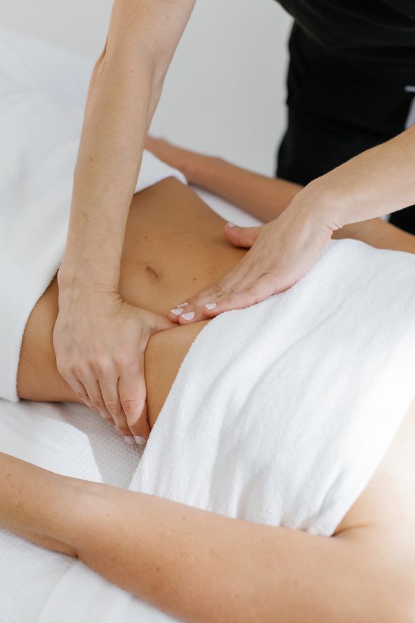 A therapist kneads a guest’s midriff as part of a treatment at Sydney’s Future Clinic. 