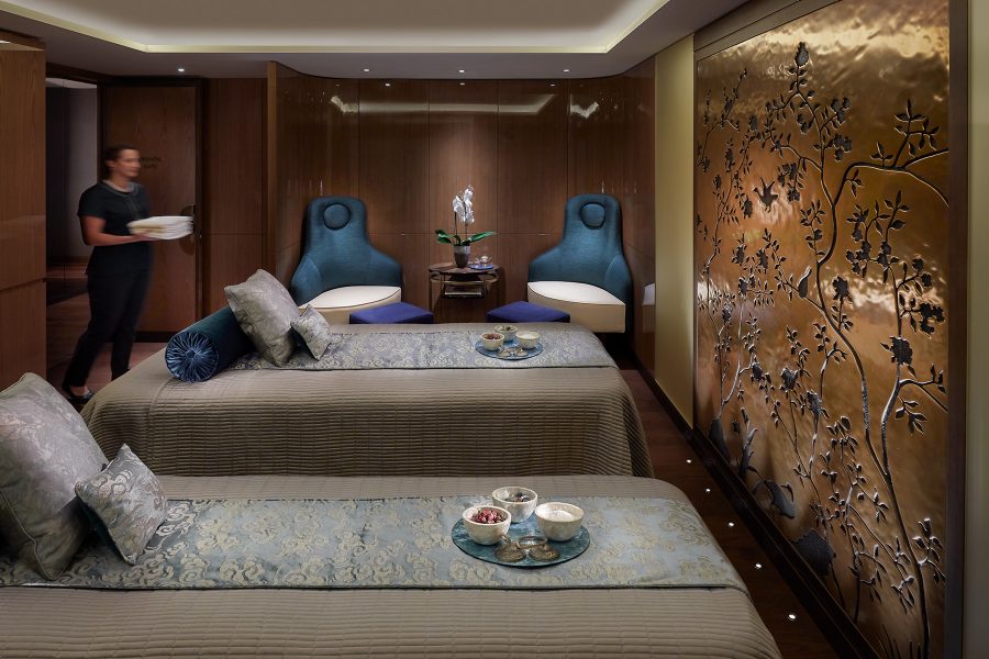 A person carries a tub into a two-person spa treatment room at Mandarin Oriental Hyde Park in London. 