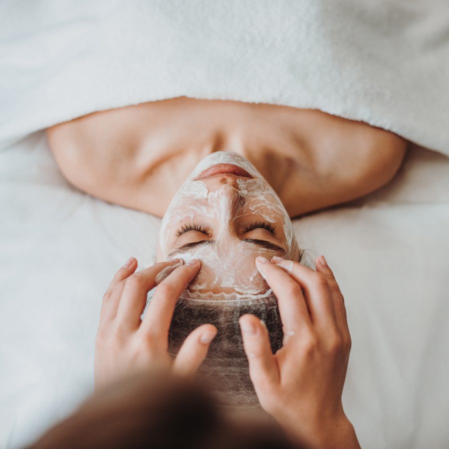 A woman lies down face up and enjoys a cryofacial, on offer at Singapore’s Porcelain Skin.