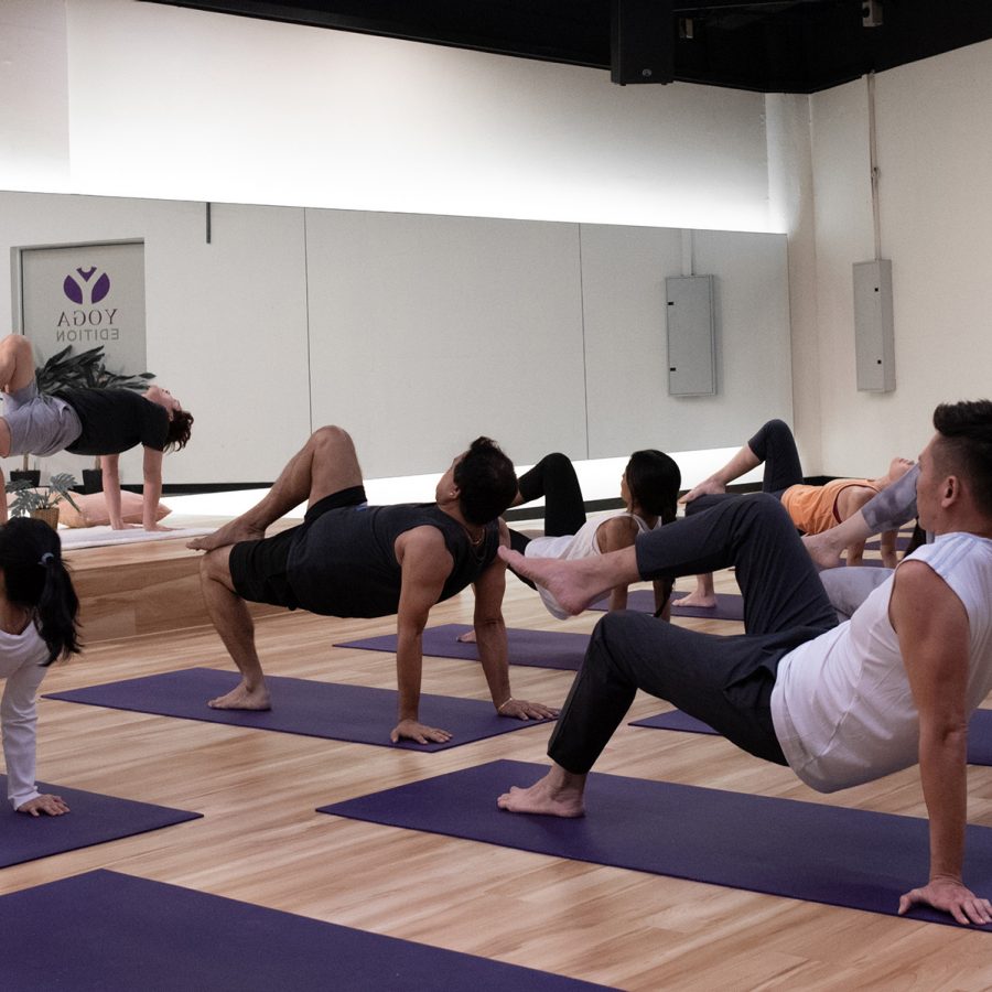 People inside a classroom practice yoga nidra at Yoga Edition in Singapore.
