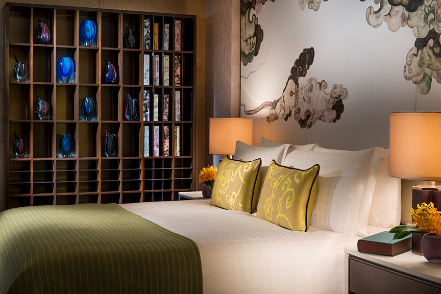 An interior view of the stylish guestroom with art and Chinese decor at the Four Seasons Hotel Shenzhen in China.