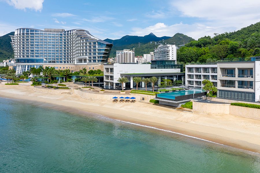 Exterior view InterContinental Shenzhen Dameisha Resort and beach on a sunny day.