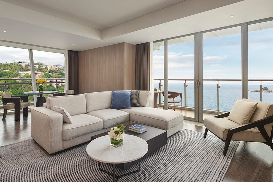 An interior view of a guest suite with outdoor balcony, terrace and living space in InterContinental Shenzhen Dameisha Resort in China.